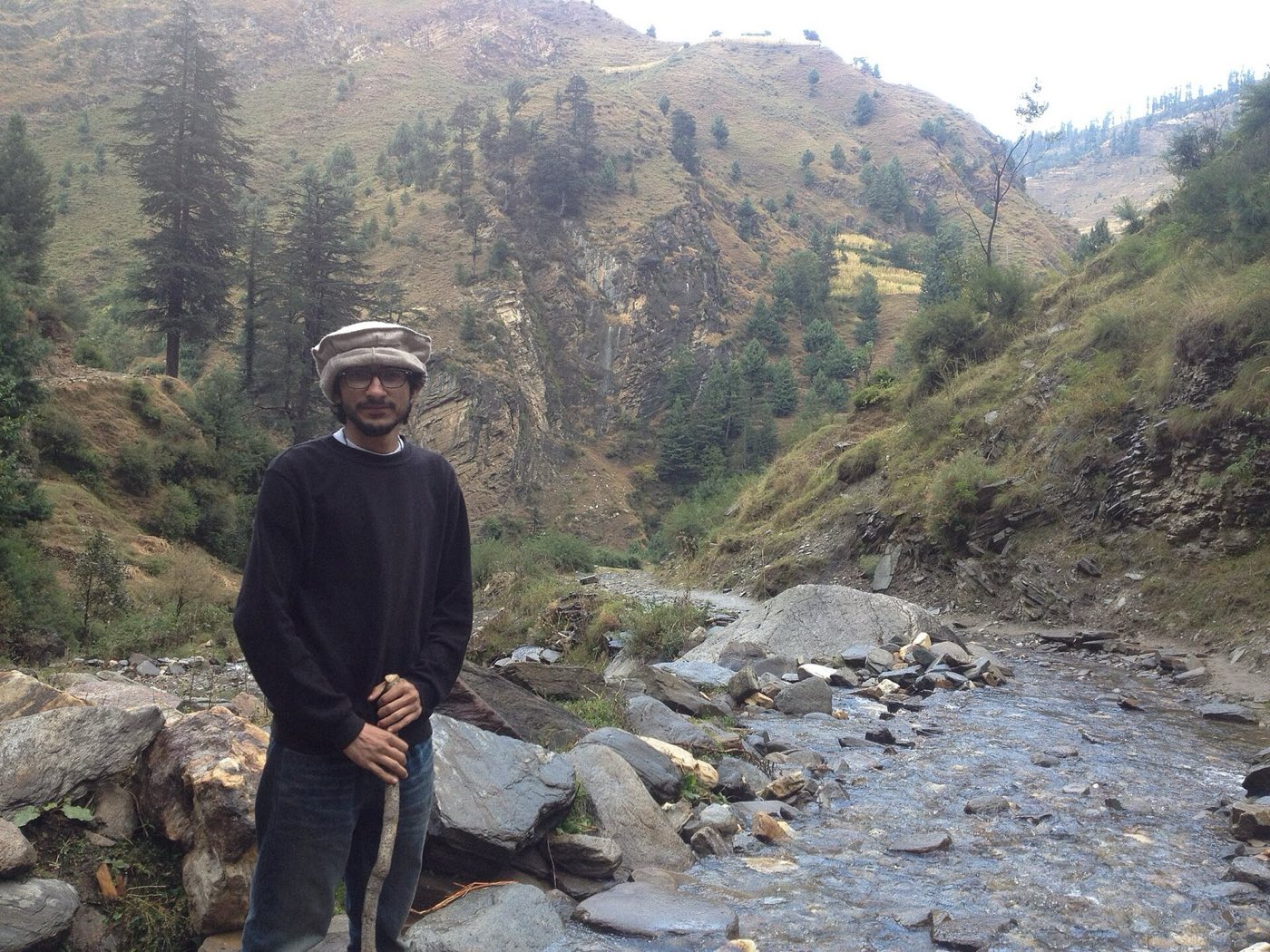 A trekker overlooking a mountain valley