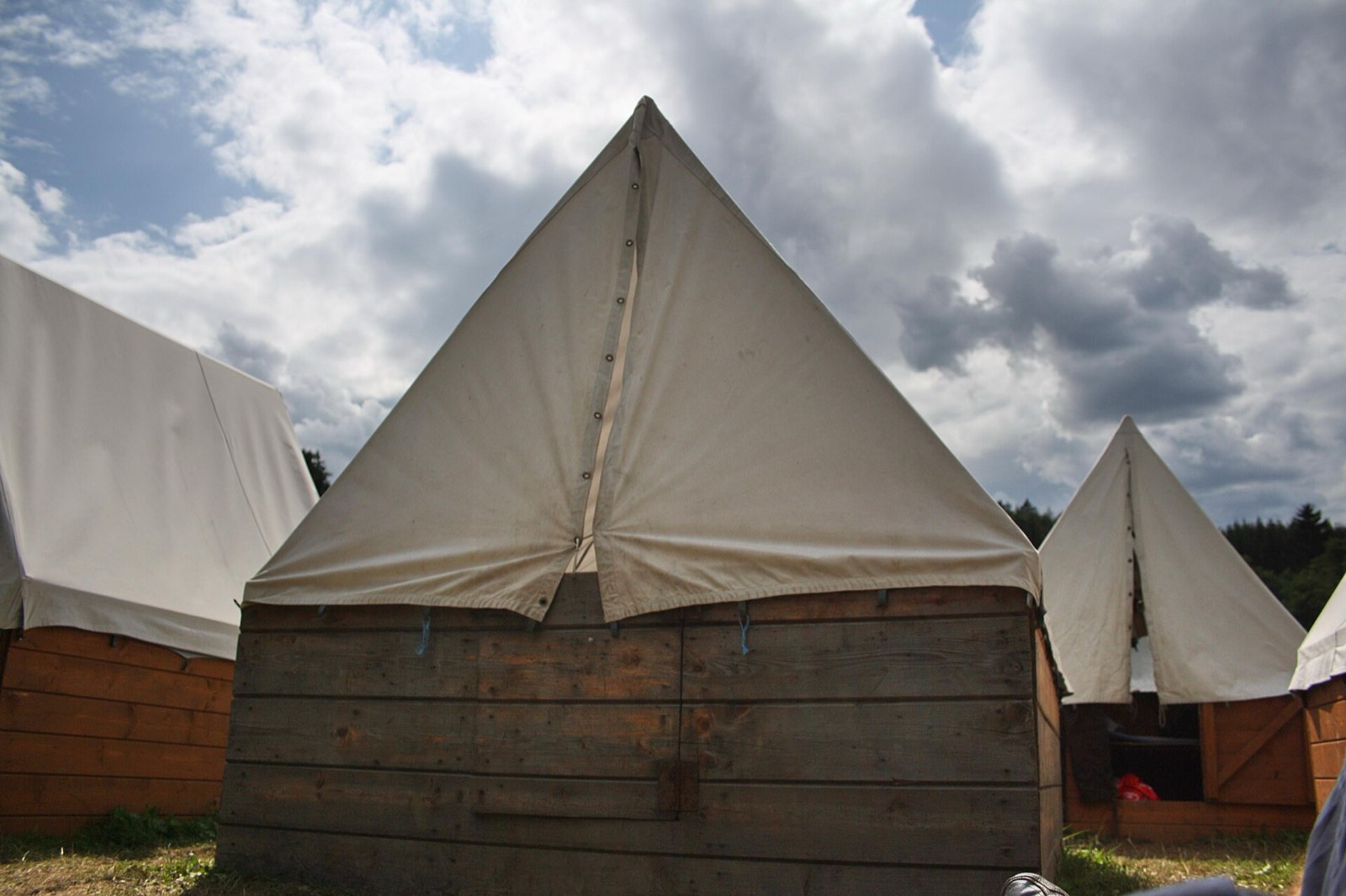 Wall tents at a summer camp under a big sky